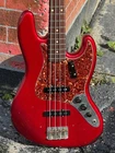 2005 Fender Jazz Bass '64 Relic Reissue Candy Apple Red W/a Matching Headstock. Used. Price: $3750.00.