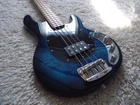 Sterling By Music Man Stingray RAY34 Neptune Blue Flame Top Bass Guitar. Used. Price: $749.99.