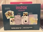 Brand New Fujifilm Instax Mini 12 Lilac Purple Camera Bundle Open. Price: $94.99.