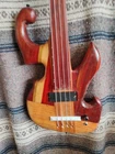 Right-hand Fretless 4 String Unique Multiwood Wishbass Short 28" Scale New. Price: $250.00.