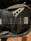 Squier Jazz Bass Black Lightly Used Electric Guitar. Price: $332.00.
