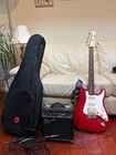 Fender Stratocaster Squier With Amplifier, Case, Cables, Strap, And Picks Used. Price: $350.00.