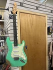 Fojill Strat Style Electric Guitar In Distressed Green Color Open. Price: $349.00.