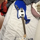 Squier Blue Electric Guitar Dual Humbucker White Pickguard Maple Neck Strap Open. Price: $200.00.