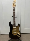 Squier 40TH Anniversary Gold Stratocaster Electric Guitar - Ruby Red Metallic Used. Price: $399.99.